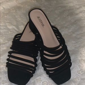 Black strappy shoes with mid heel.